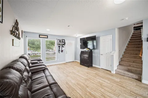 a bedroom with furniture and a large window