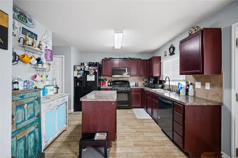 a kitchen with granite countertop stainless steel appliances and wooden cabinets