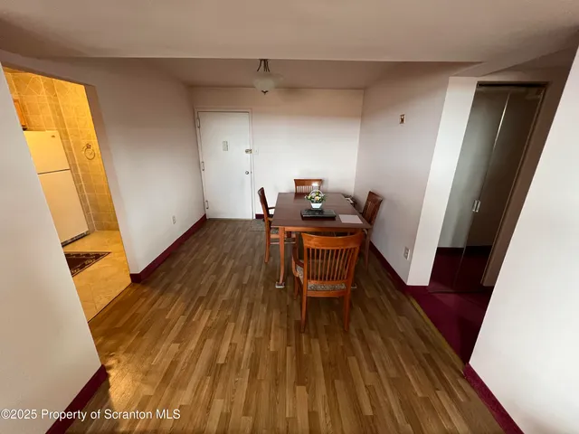 a view of a room with wooden floor and bench