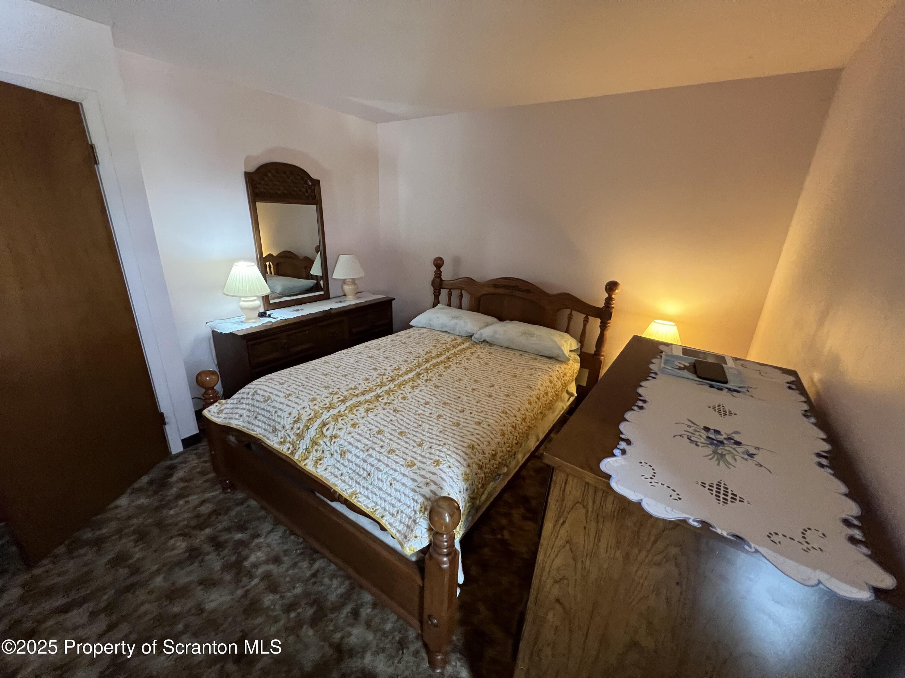 220 Linden Street, Unit 604 Scranton, PA 18503 - Photo 4 of 9 a bed sitting in a bedroom next to a window