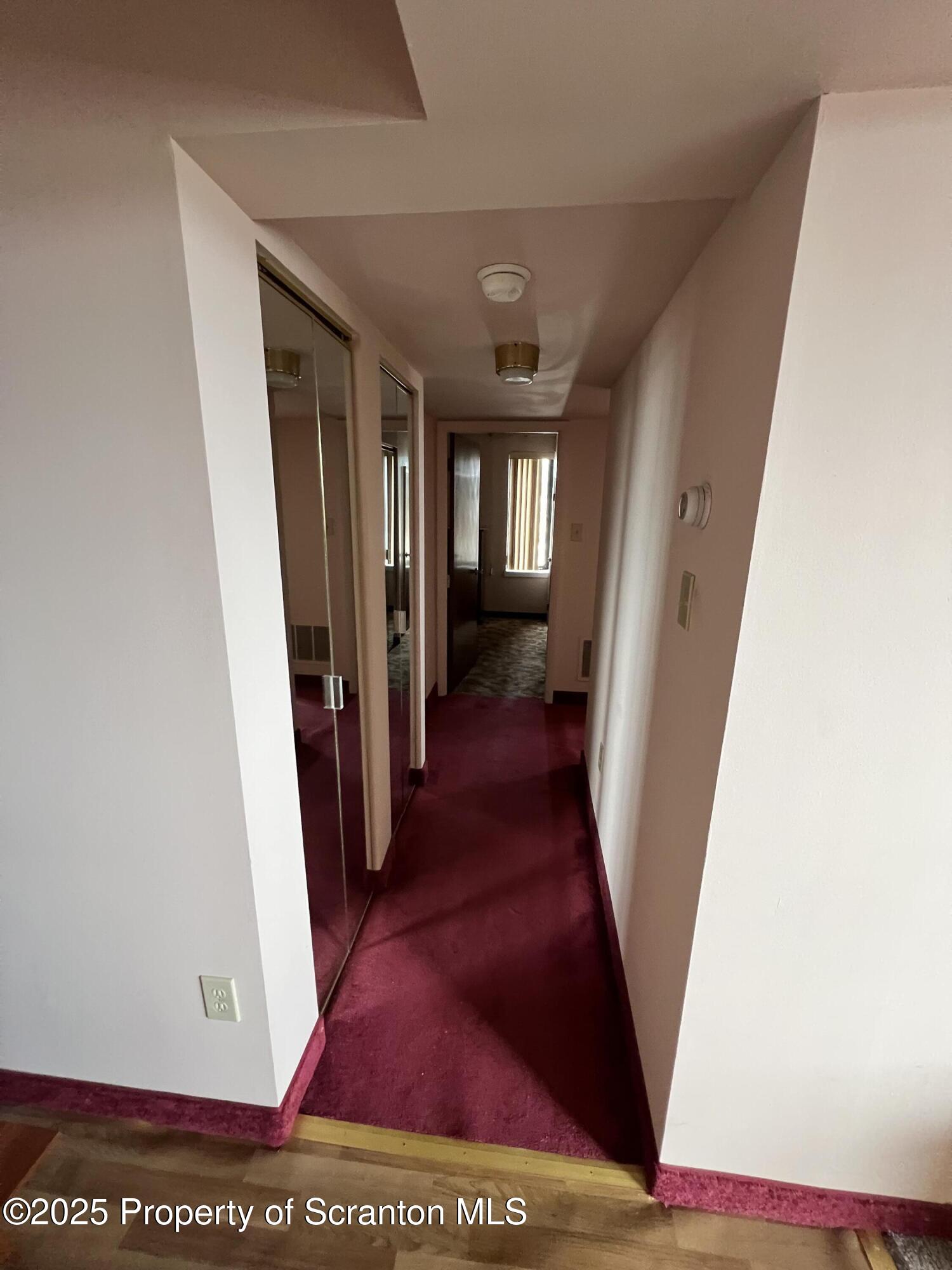 220 Linden Street, Unit 604 Scranton, PA 18503 - Photo 6 of 9 a view of a hallway with wooden floor and staircase