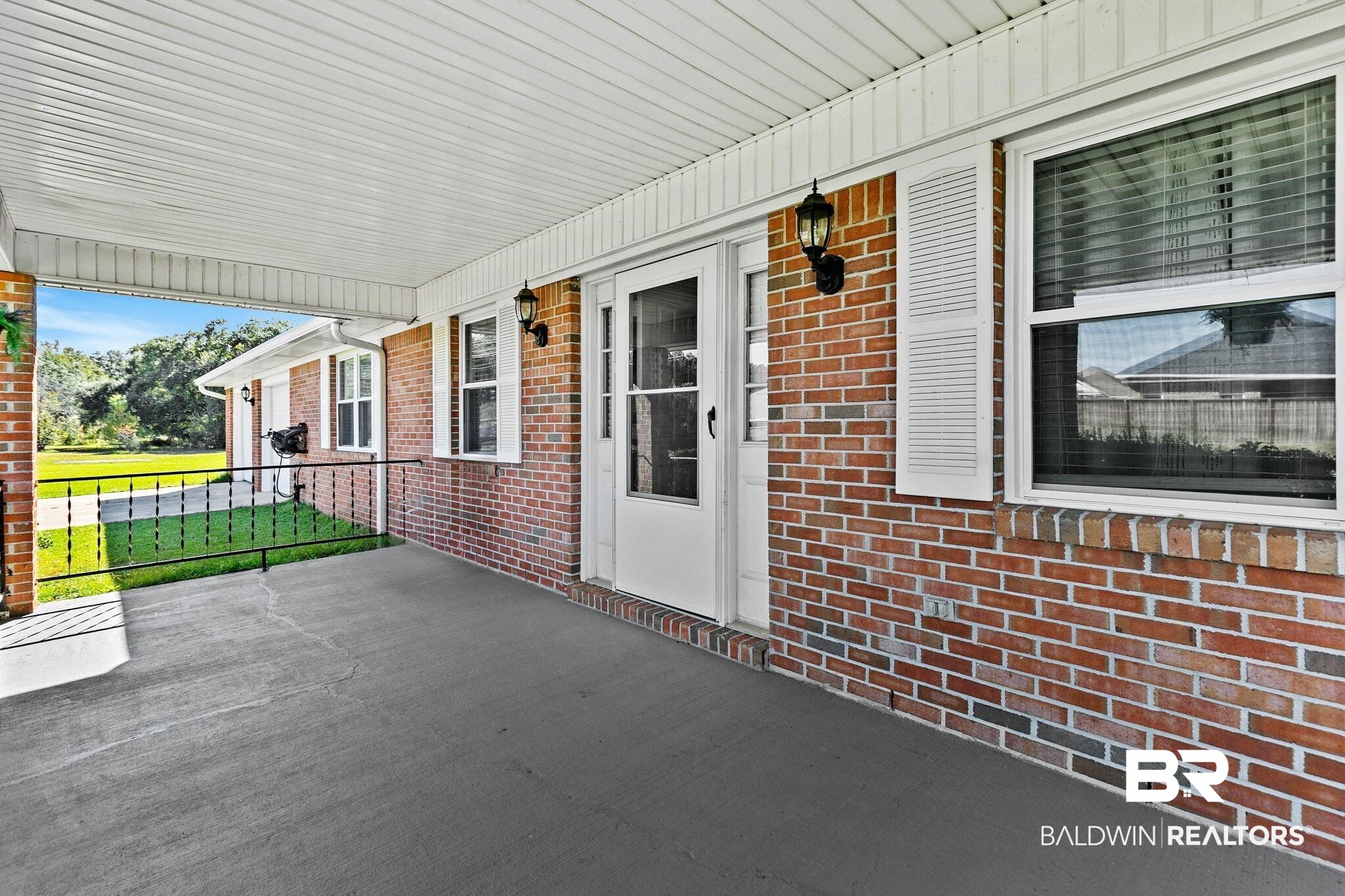 1510 South Juniper Street Foley, AL 36535 - Photo 7 of 36 Covered porch featuring a lawn
