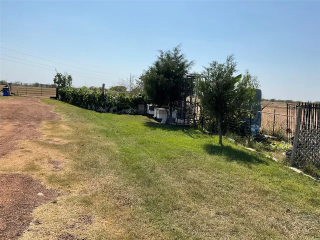 a view of a field of grass and trees
