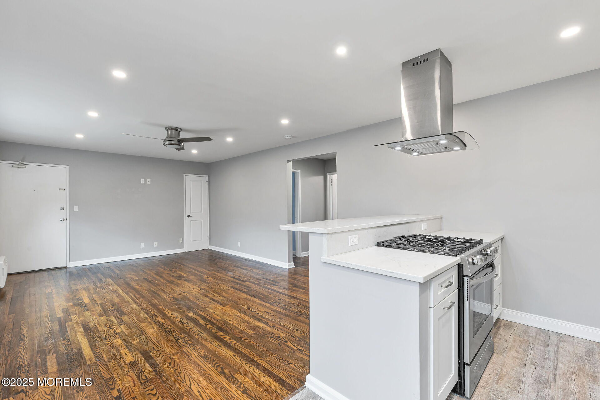293 Spring Street, Unit 15D Red Bank, NJ 07701 - Photo 10 of 28 a kitchen that has a stove and a wooden floor