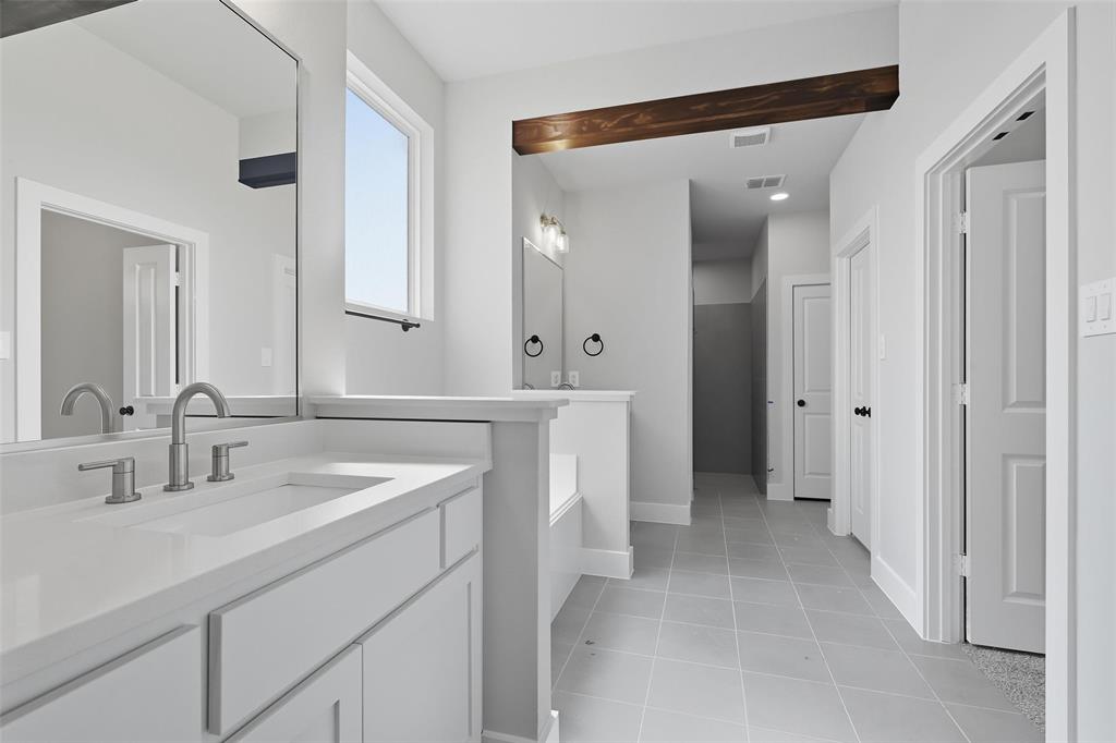 1005 Ronnie Court Springtown, TX 76082 - Photo 18 of 27 Full bathroom with two vanities and light tile patterned floors