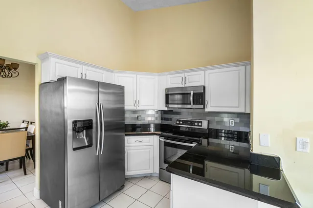 a kitchen with stainless steel appliances a refrigerator sink and stove