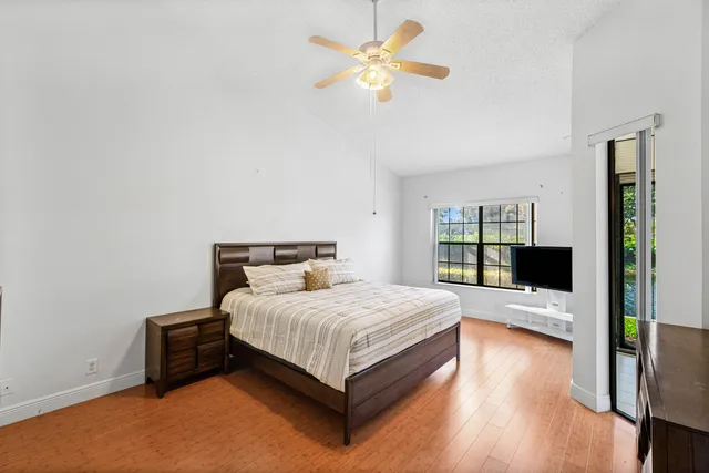 a bedroom with a bed and a flat tv screen on a dresser