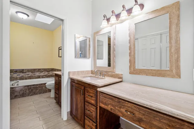 a bath room with a sink and a mirror