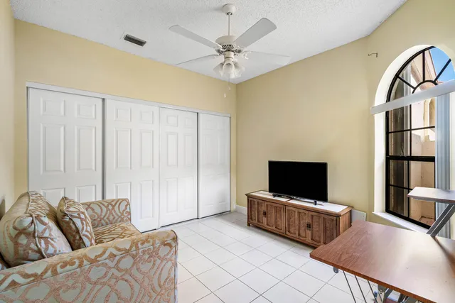 a bathroom with a granite countertop sink mirror vanity and toilet