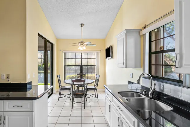 a kitchen with granite countertop a sink and a stove