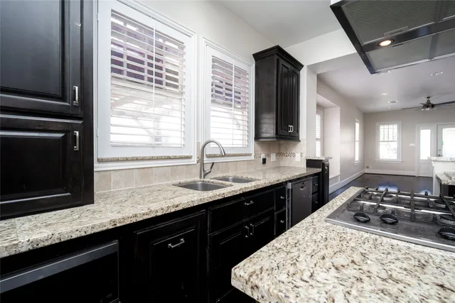 a kitchen with stainless steel appliances granite countertop a sink stove and cabinets