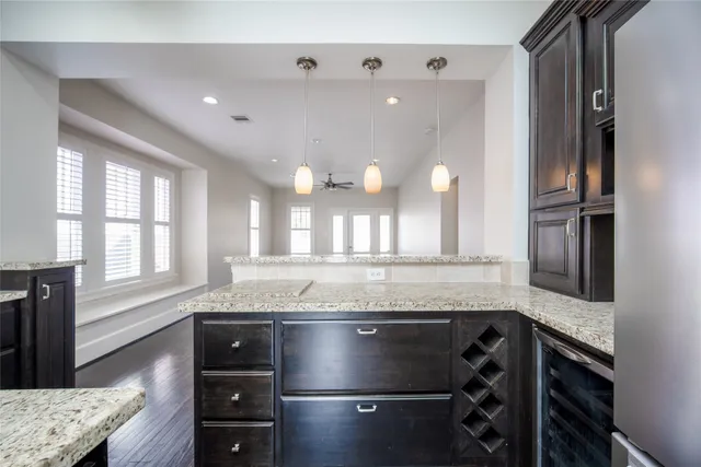 a kitchen with granite countertop a stove and a sink