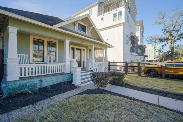 a view of a house with a yard and deck