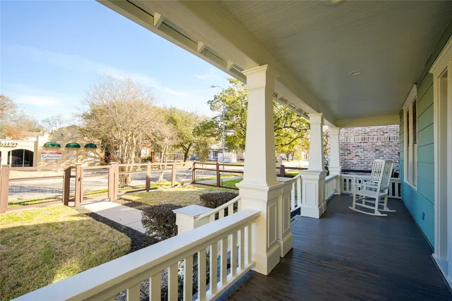 a living room with furniture floor to ceiling windows and wooden floor