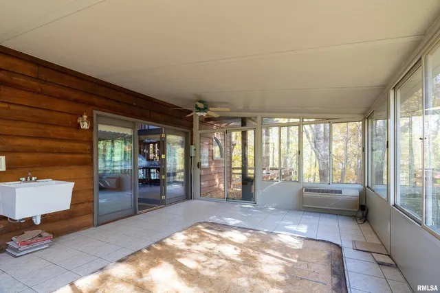 a view of a hallway with wooden shelves