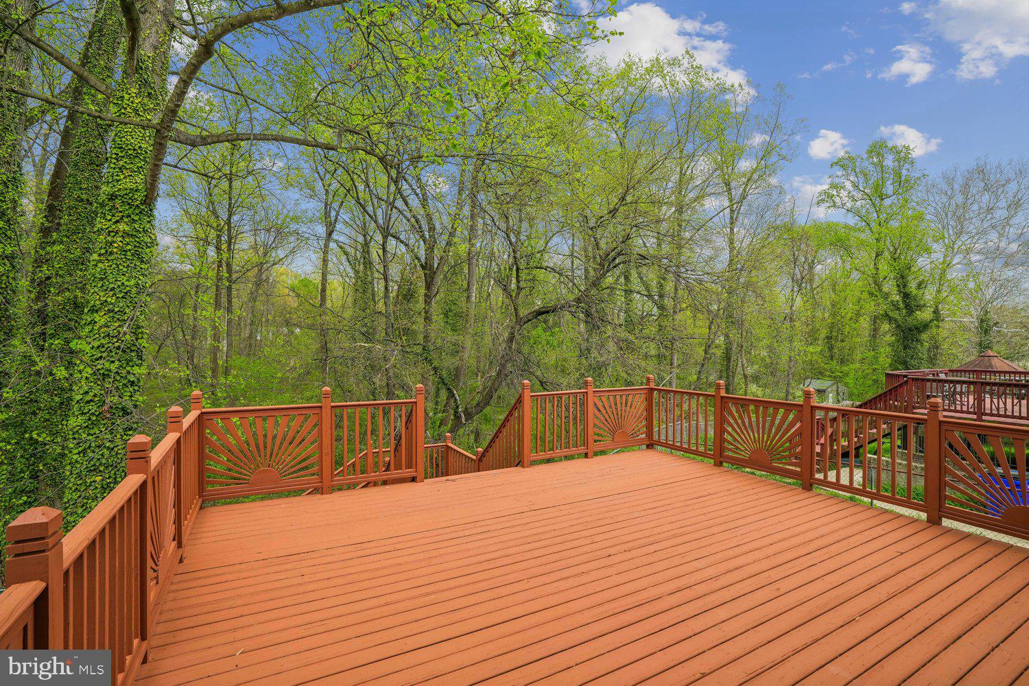 9955 Guilford Road Jessup, MD 20794 - Photo 32 of 45 Serene deck overlooking lush greenery.
