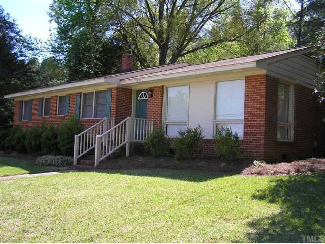 3015 Brentwood Road Raleigh, NC 27604 - Photo 1 of 12 a backyard of a house with plants and large tree