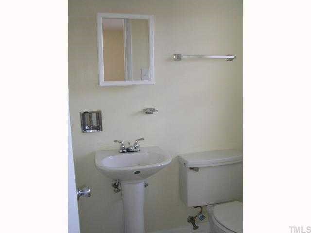 3015 Brentwood Road Raleigh, NC 27604 - Photo 11 of 12 a bathroom with a sink a toilet and mirror
