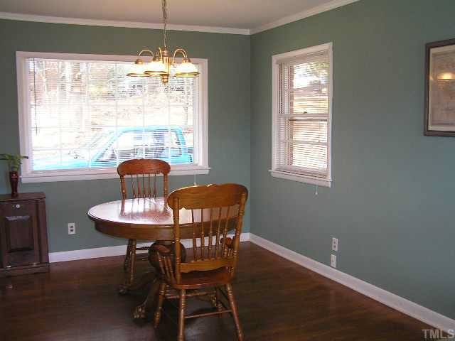 3015 Brentwood Road Raleigh, NC 27604 - Photo 5 of 12 a dining room with furniture a chandelier and wooden floor
