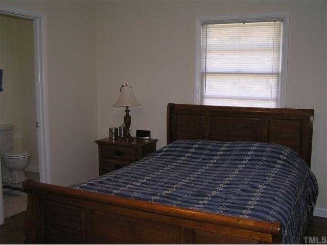 3015 Brentwood Road Raleigh, NC 27604 - Photo 10 of 12 a bedroom with a bed and a window