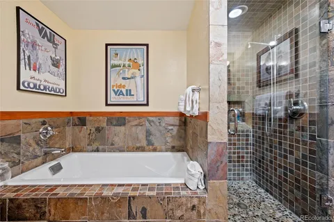 a bathroom with a bathtub and shower