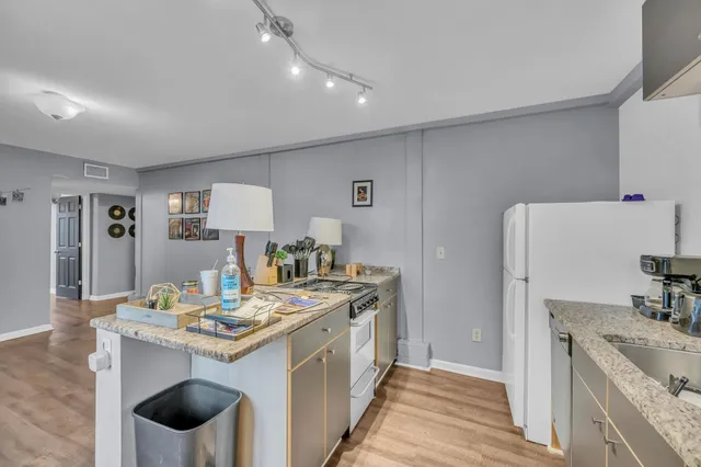 a kitchen with a sink stove and refrigerator