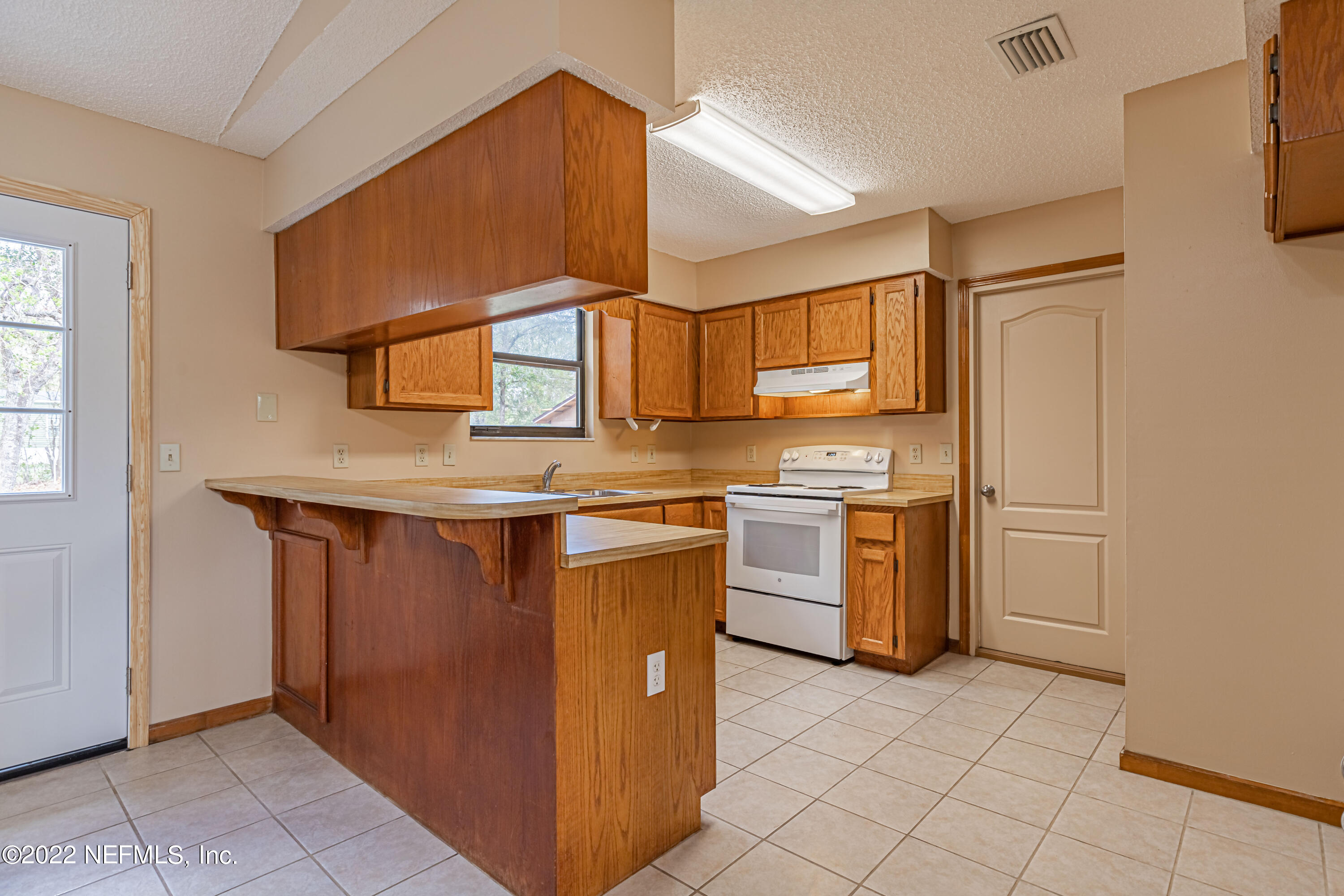 3970 Pinto Road Middleburg, FL 32068 - Photo 29 of 53 a kitchen with stainless steel appliances granite countertop a stove a sink and a refrigerator