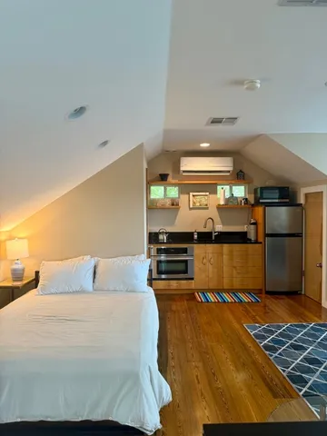 a bedroom with a bed and window