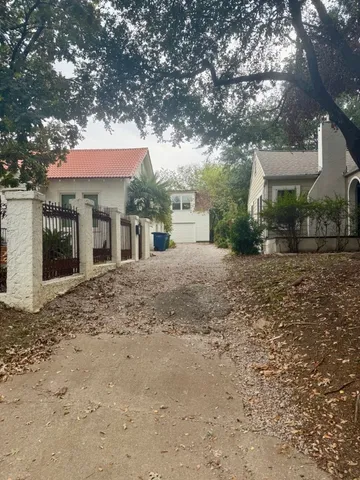 a front view of a house with a tree