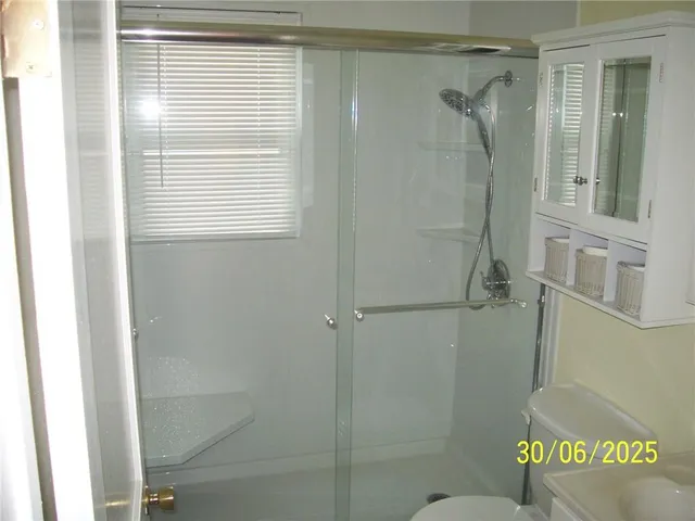 a bathroom with a shower and a sink