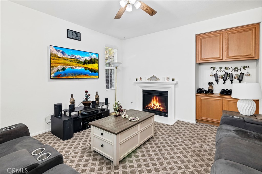 40494 Corrigan Place Temecula, CA 92591 - Photo 14 of 67 a living room with furniture a fireplace and window