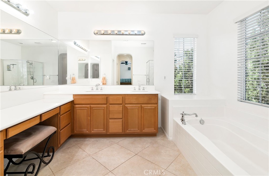 40494 Corrigan Place Temecula, CA 92591 - Photo 39 of 67 a bathroom with a granite countertop sink mirror and a bathtub