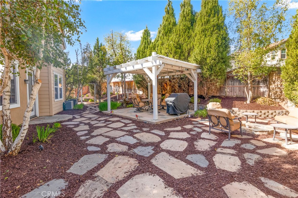 40494 Corrigan Place Temecula, CA 92591 - Photo 45 of 67 a view of a patio with table and chairs under an umbrella