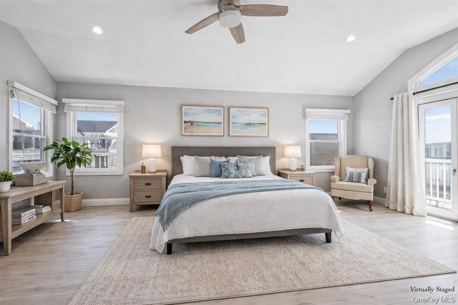 71 Michigan Street Long Beach, NY 11561 - Photo 17 of 48 a spacious bedroom with a bed a couch and a window