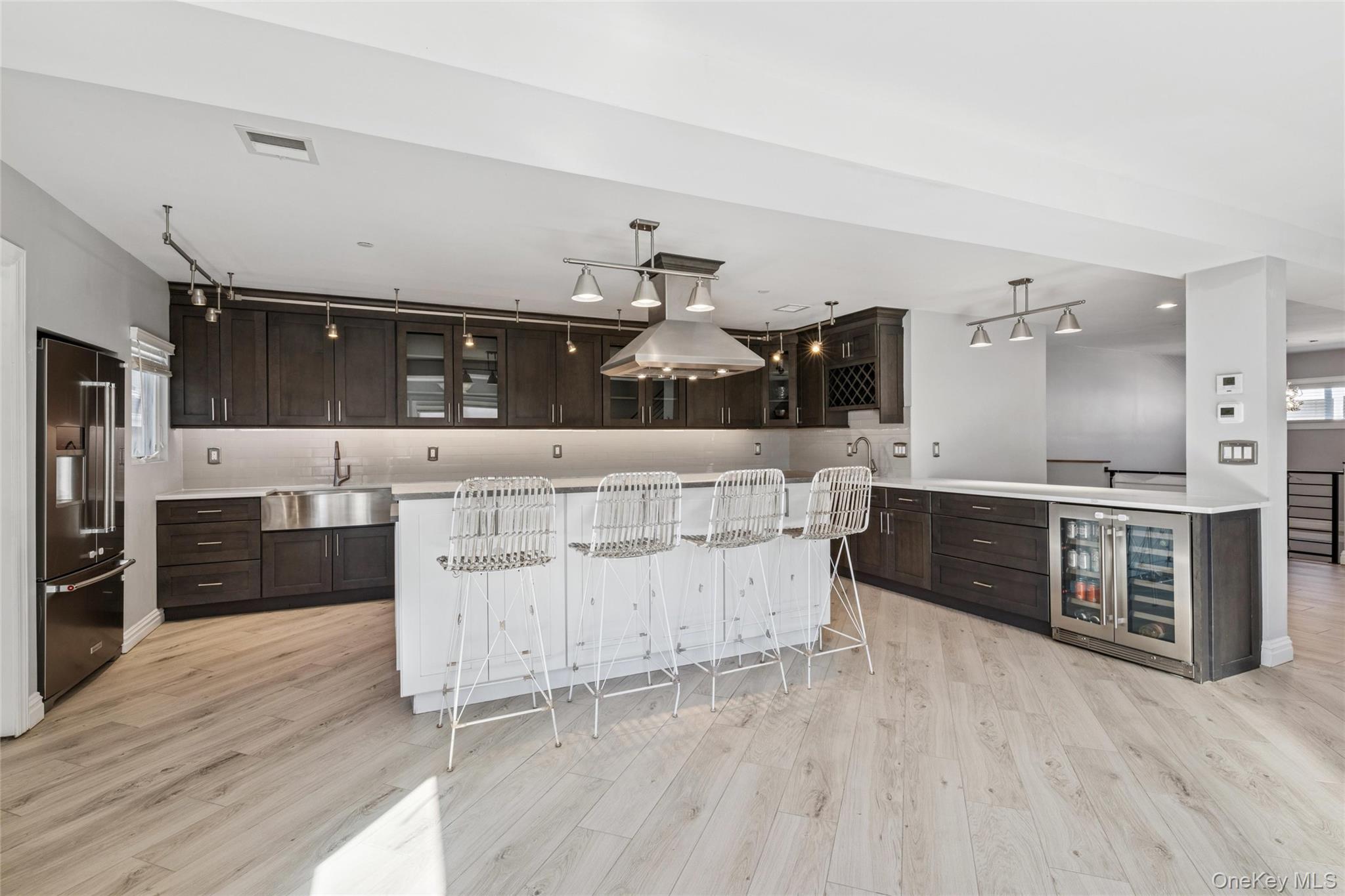 71 Michigan Street Long Beach, NY 11561 - Photo 2 of 48 a large kitchen with stainless steel appliances kitchen island granite countertop a large counter top and wooden floors