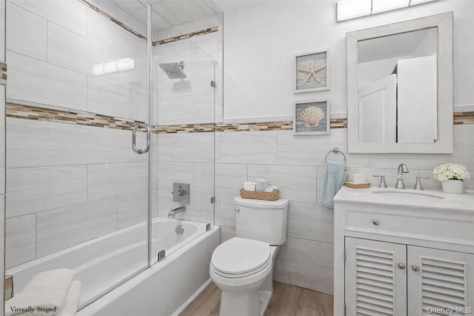 71 Michigan Street Long Beach, NY 11561 - Photo 26 of 48 a bathroom with a granite countertop toilet a sink and bathtub