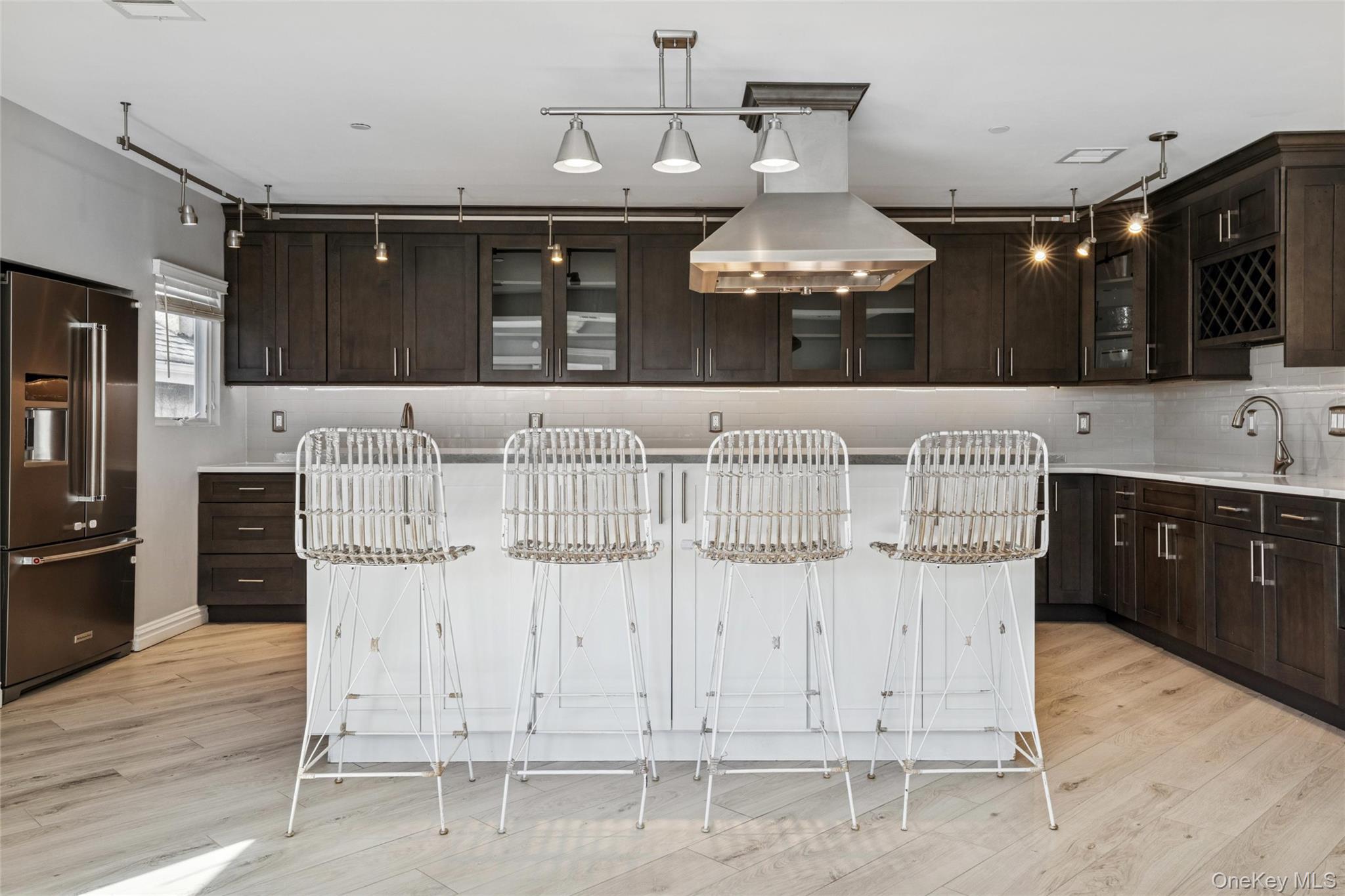 71 Michigan Street Long Beach, NY 11561 - Photo 3 of 48 a kitchen with cabinets and chairs