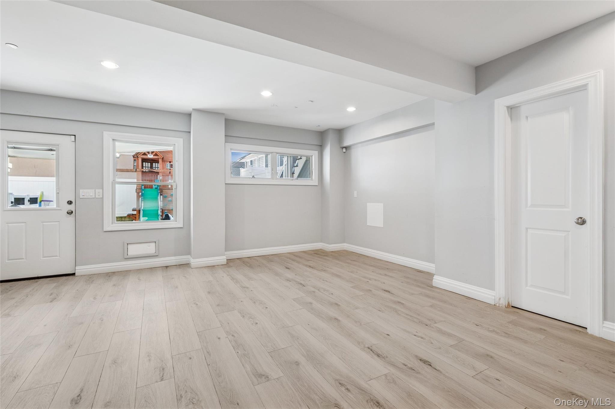 71 Michigan Street Long Beach, NY 11561 - Photo 36 of 48 wooden floor in an empty room with a window