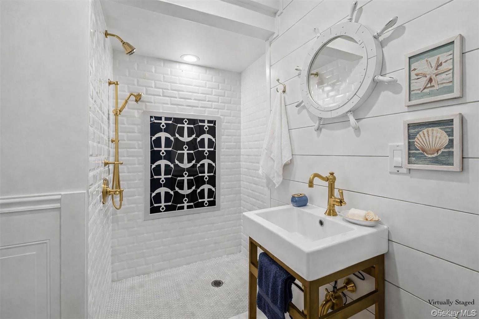 71 Michigan Street Long Beach, NY 11561 - Photo 37 of 48 a bathroom with a sink a mirror and shower