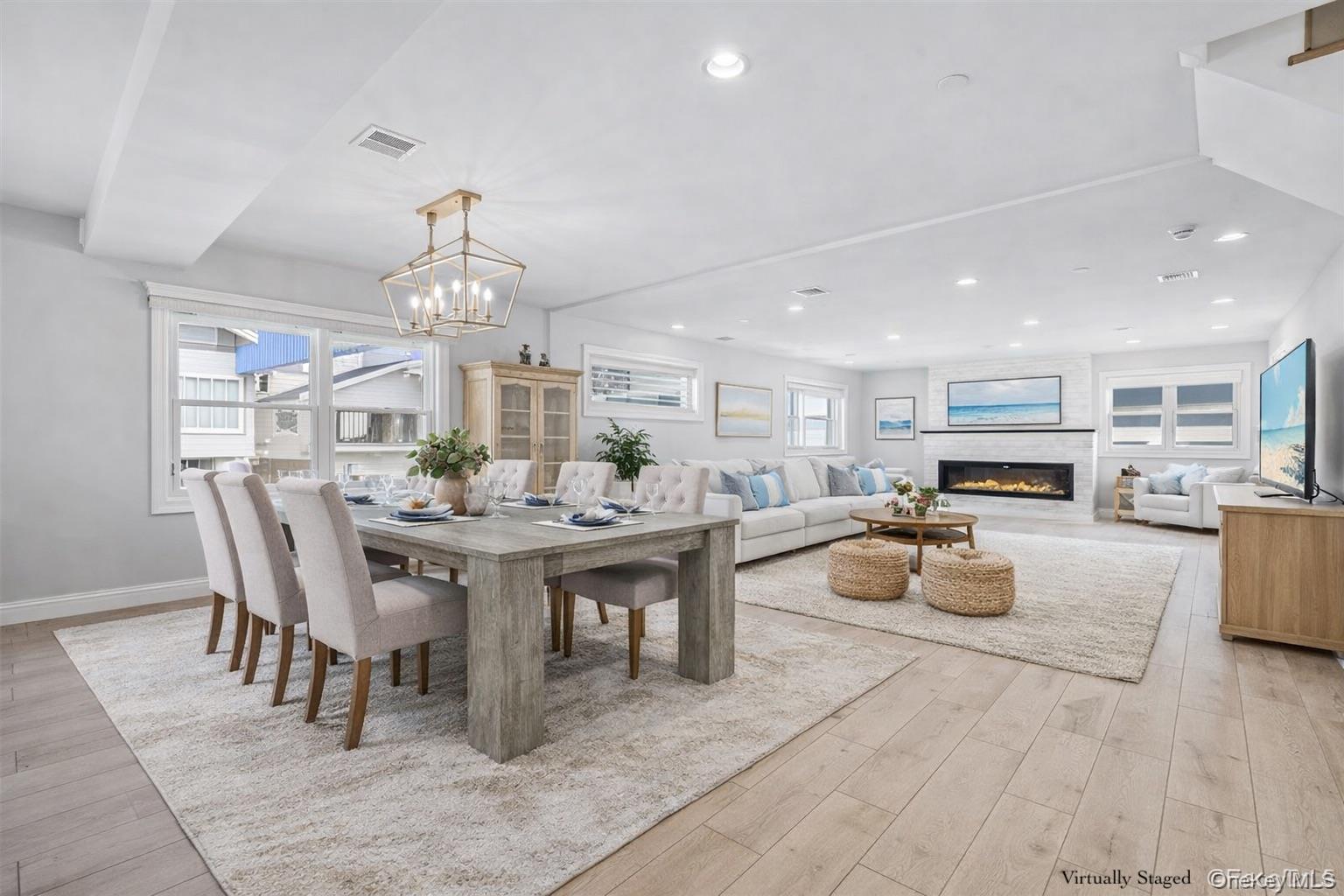 71 Michigan Street Long Beach, NY 11561 - Photo 8 of 48 a view of a dining room with furniture a kitchen and chandelier
