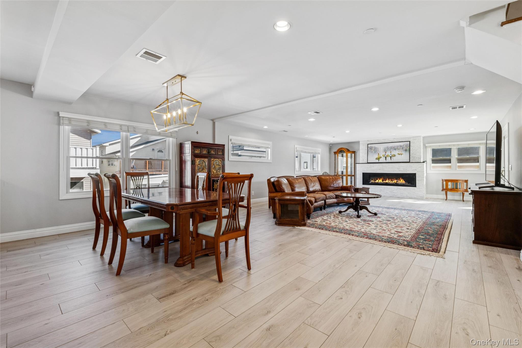 71 Michigan Street Long Beach, NY 11561 - Photo 9 of 48 a view of a dining room with furniture wooden floor and chandelier