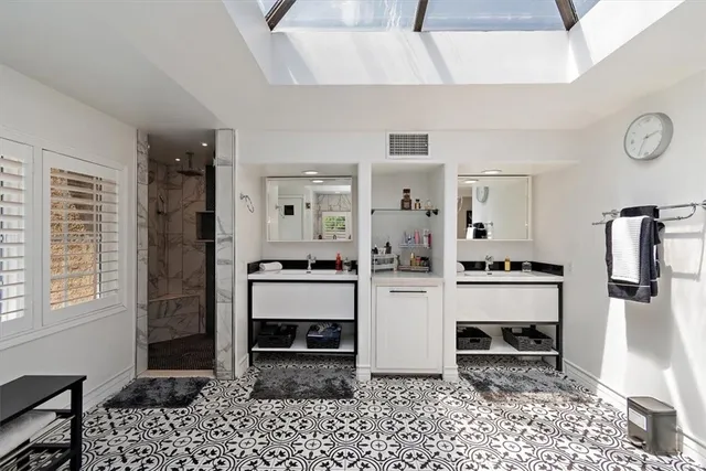a bathroom with a double vanity sink and a mirror