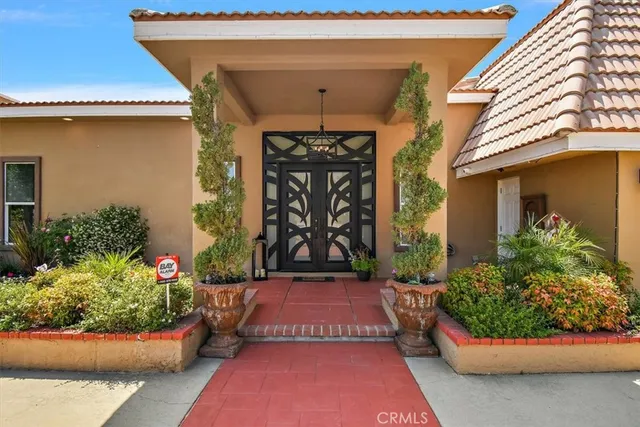 an aerial view of a house with swimming pool garden and patio