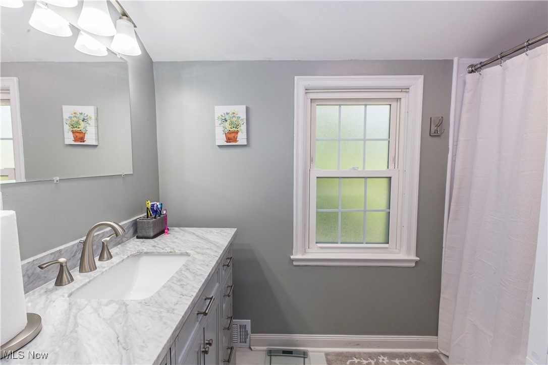 2113 Stabler Road Akron, OH 44313 - Photo 29 of 39 Second Floor full remodeled Bathroom featuring vanity and curtained shower
