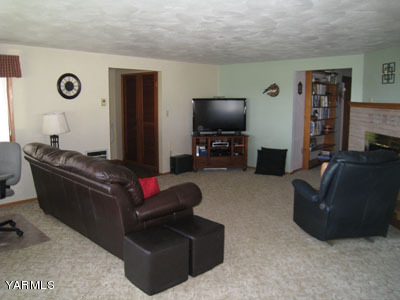704 Meadowbrook Road Yakima, WA 98903 - Photo 7 of 33 a living room with furniture and a flat screen tv