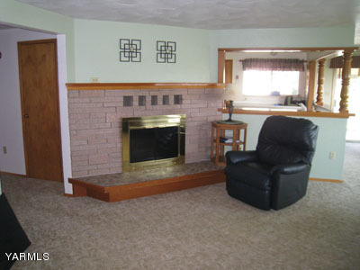704 Meadowbrook Road Yakima, WA 98903 - Photo 8 of 33 a living room with furniture and a fireplace