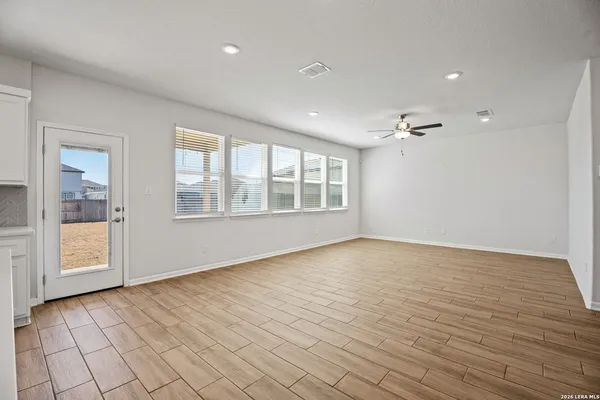 a kitchen with a sink window and cabinets