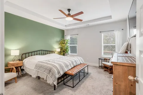 a bedroom with a bed and a window