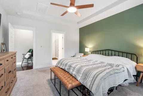 a bedroom with a bed and a chandelier