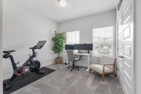 a view of a livingroom with workspace and a window